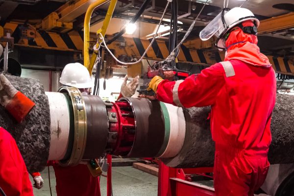 Welding the pipeline for laying on the seabed. Work in a pipe-layer.